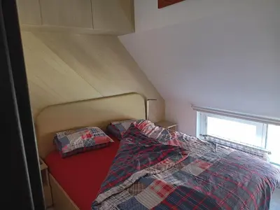 a bed with two pillows on it in a room at Bright apartment at a great location in Sofia