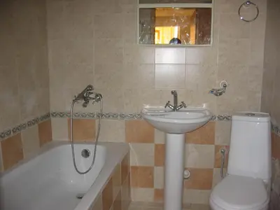 a bathroom with a sink and a toilet and a bath tub at Hotel Deva in Sandanski