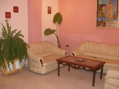 a living room with two couches and a coffee table at Hotel Deva in Sandanski
