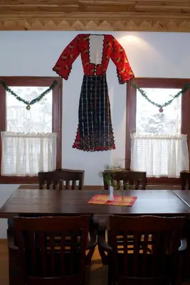a dress hanging above a table in a dining room at Complex Kosovo Houses in Kosovo
