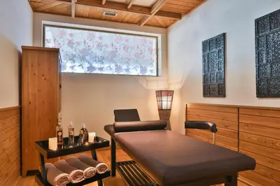 a room with a table and a chair and a window at Pirin Golf & Country Club Apartment Complex in Bansko