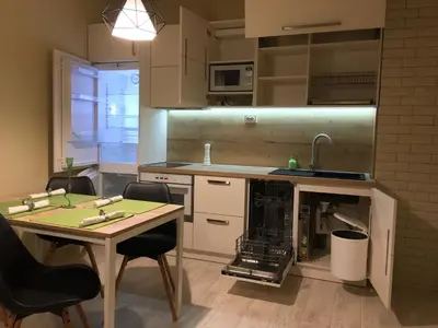 a kitchen with a table and chairs and a sink at Evergreen Sofia Apartment in Sofia