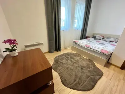 a small room with a bed and a table and a table sidx sidx at New Inn in Bansko
