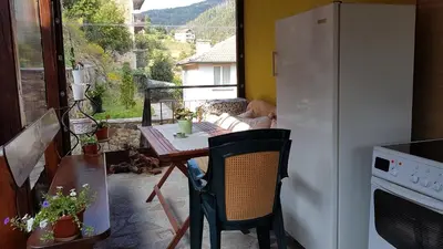 a small kitchen with a table and a refrigerator at 