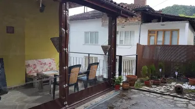 an open balcony with chairs and a house at 