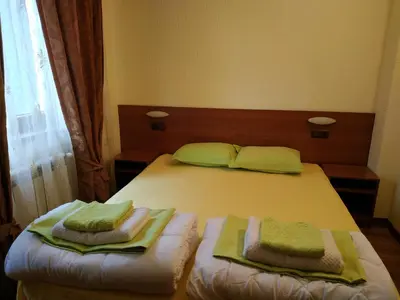 a bedroom with a bed with two towels on it at 