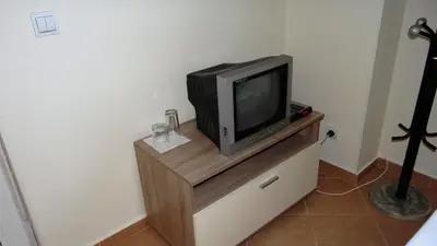 a small television sitting on top of a dresser at Guest Rooms Kom in Sofia