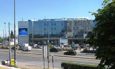 a busy city street with a large glass building at Guest Rooms Kom in Sofia