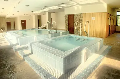 a large swimming pool with two reservoirs in a building at Spa Hotel Planinata in Ribarica
