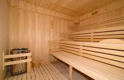 a wooden sauna with a wooden bench in a room at Spa Hotel Planinata in Ribarica