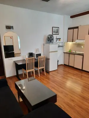 a living room with a kitchen and a table in it at Studio Cathlyn in Sofia