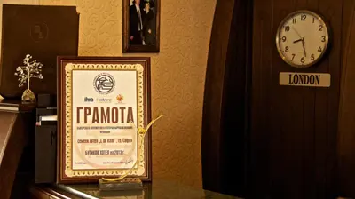 a framed sign on a table next to a clock at Boutique Hotel L do Rado in Sofia