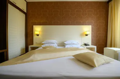 a bedroom with two beds and two tables and two lamps at Boutique Hotel L do Rado in Sofia