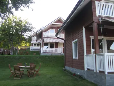 a house with a table and chairs in the yard at Holiday Village Orlino in Sarnitsa
