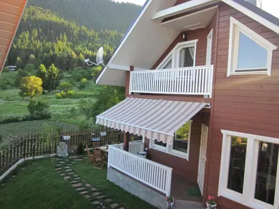 a house with awnings on the side of it at Holiday Village Orlino in Sarnitsa