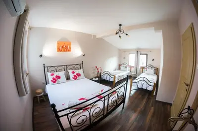 a bedroom with two beds and a hallway at The Old House guest rooms and apartament in Plovdiv