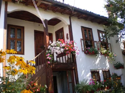 a house with flower boxes on the balcony at Tsutsovi House in Kalofer