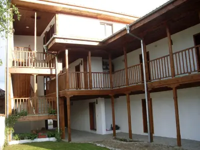 a large building with wooden balconies on it at Tsutsovi House in Kalofer