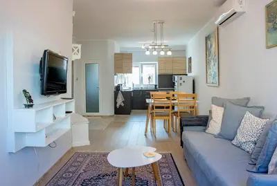 a living room with a couch and a table at Cozy Apartment in the very centre of Sofia in Sofia