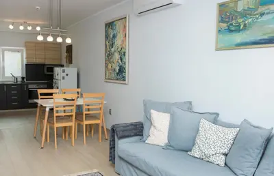 a living room with a couch and a table at Cozy Apartment in the very centre of Sofia in Sofia