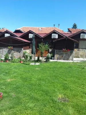 a house with a lawn in front of it at Къща Момина сълза in Sapareva Banya