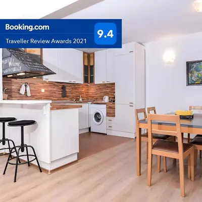 a kitchen with white cabinets and a table and chairs at Eleganto - Central 2BD Stylish Apartment by Flat Mаnager in Sofia