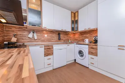 a kitchen with white cabinets and a washer and dryer at Eleganto - Central 2BD Stylish Apartment by Flat Mаnager in Sofia