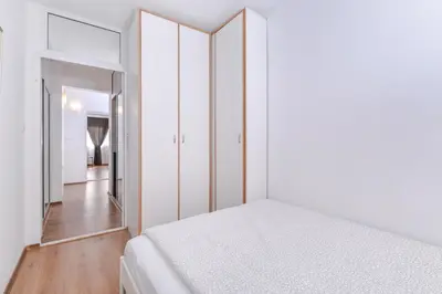 a white bedroom with a bed and a mirror at Eleganto - Central 2BD Stylish Apartment by Flat Mаnager in Sofia