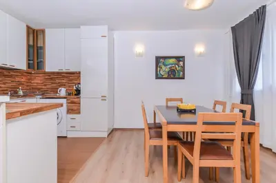a kitchen and dining room with a table and chairs at Eleganto - Central 2BD Stylish Apartment by Flat Mаnager in Sofia