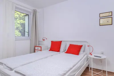 a white bedroom with red pillows on a bed at Eleganto - Central 2BD Stylish Apartment by Flat Mаnager in Sofia