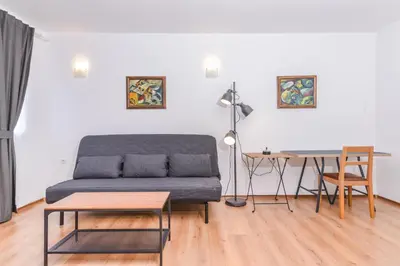 a living room with a couch and a table at Eleganto - Central 2BD Stylish Apartment by Flat Mаnager in Sofia