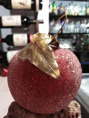 a butterfly sitting on top of a red apple at Complex Magic of the Rhodopes in Bachkovo