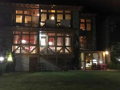 a building with a staircase in front of it at night at Katarino Villa Nature Escape in Razlog