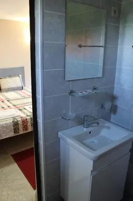 a bathroom with a sink and a mirror at Apartment Raya in Sapareva Banya