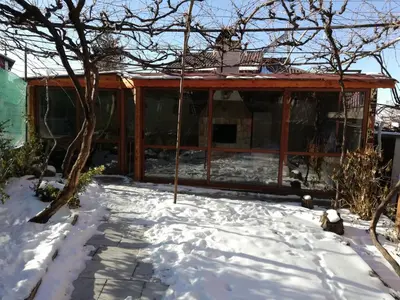a house with snow on the ground in front of it at Apartment Raya in Sapareva Banya