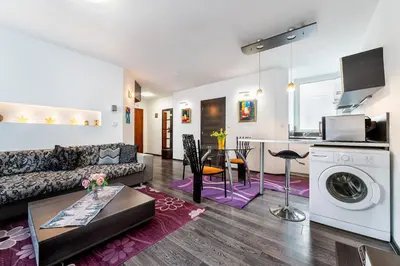 a living room with a couch and a table and a kitchen at Apartments Rosina in Plovdiv