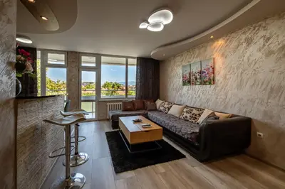 a living room with a couch and a table at Apartments Rosina in Plovdiv