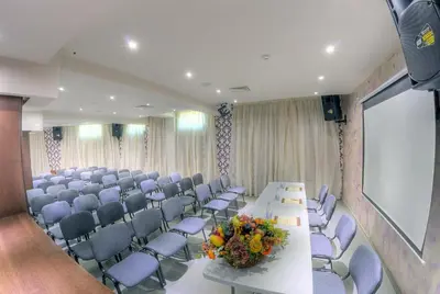 a conference room with a long table and chairs at Hotel Iva & Elena in Pamporovo