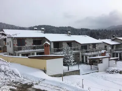 a group of houses with snow on them at Къщи за гости Илиеви , Цигов Чарк in Batak