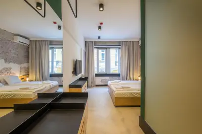 a hotel room with two beds and a mirror at R34 Boutique Hotel in Sofia