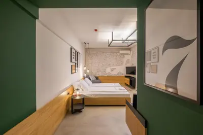 a bedroom with a bed and a green wall at R34 Boutique Hotel in Sofia