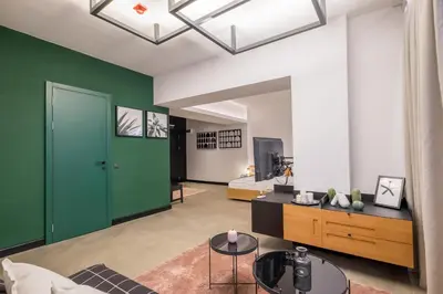 a living room with a green door and a couch at R34 Boutique Hotel in Sofia