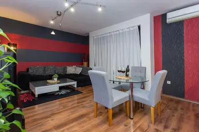 a living room with a table and chairs and a couch at Vitosha Downtown Apartments in Sofia