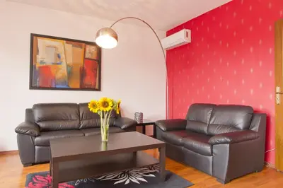 a living room with two leather chairs and a table at Vitosha Downtown Apartments in Sofia