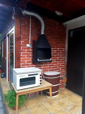 a microwave sitting on a table next to a brick wall at Guest Rooms IDeR in Sapareva Banya