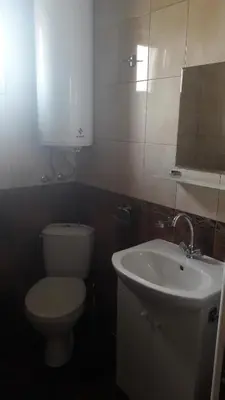 a bathroom with a toilet and a sink at Guest Rooms IDeR in Sapareva Banya