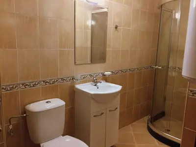a bathroom with a toilet and a sink and a shower at Northstar Ski Apartment in Mountain Lake Hotel in Pamporovo