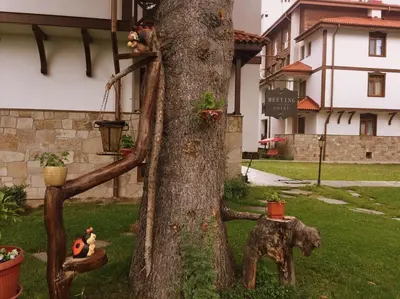 a statue of an elephant standing next to a tree at Northstar Ski Apartment in Mountain Lake Hotel in Pamporovo