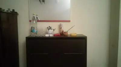 a black dresser in a corner of a room at Къща за гости Пеневи in Sofia
