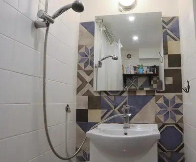 a bathroom with a shower and a toilet and a mirror at Sofia Center Cave in Sofia